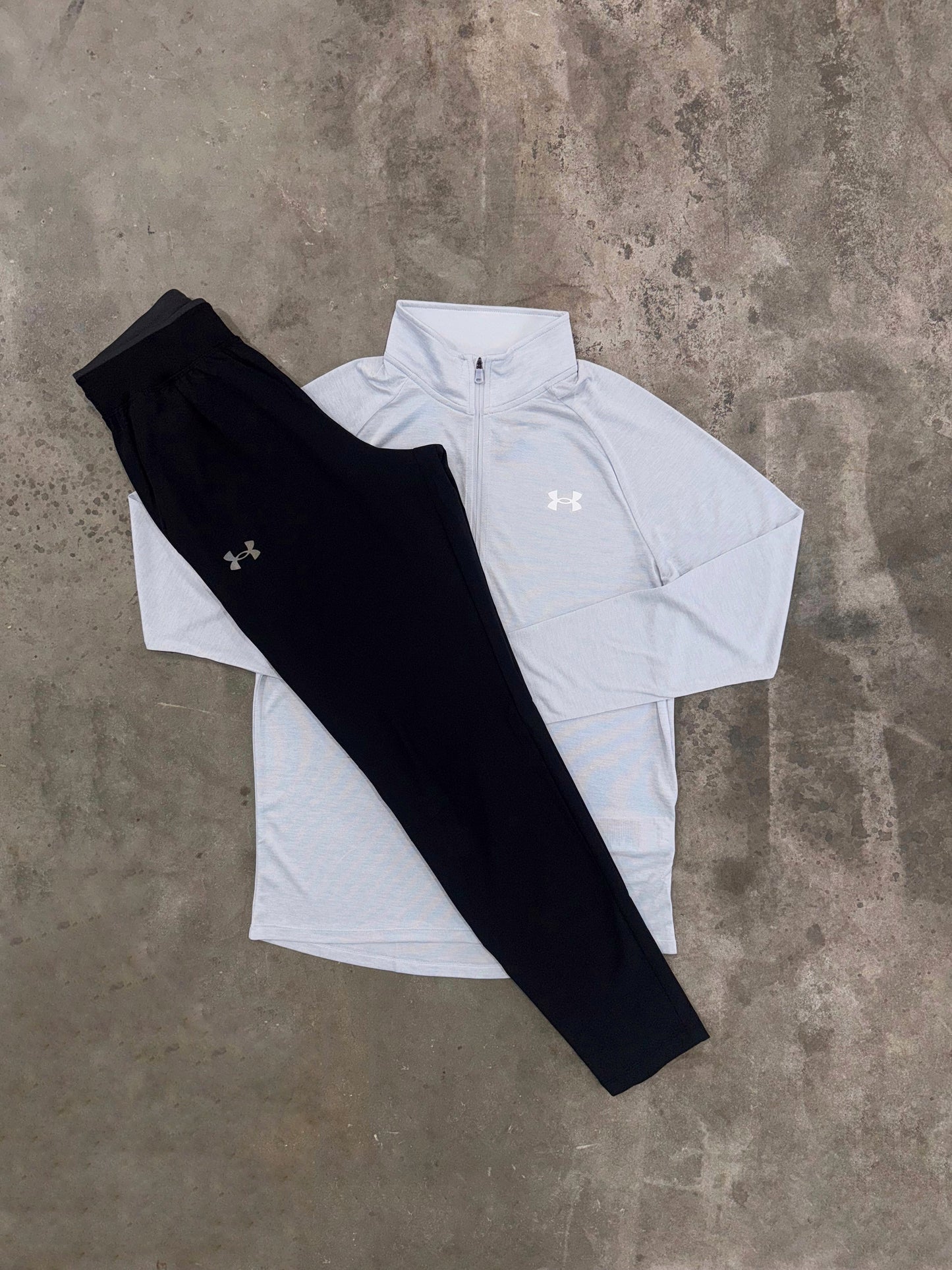 Light grey quarter zip with black pants
